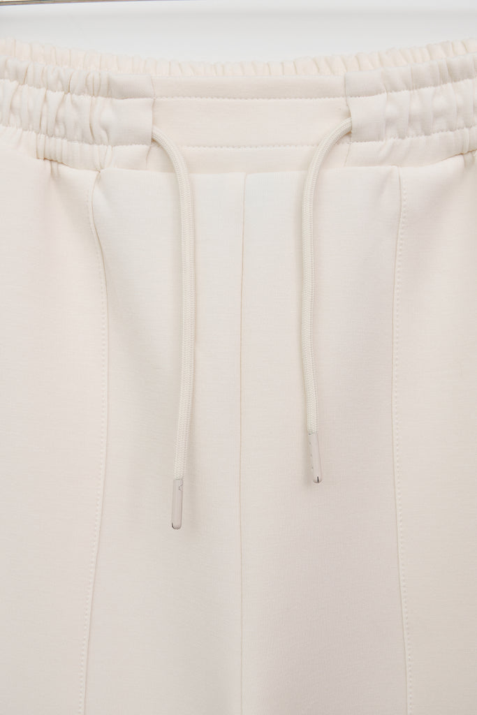 Pantalón jogger confeccionado en tejido interlock de mujer Tantä. Color blanco roto